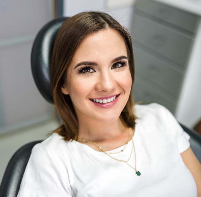 Smiling woman sitting in dental chair