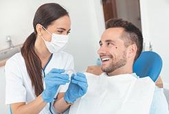 Dentist and patient smiling at each other